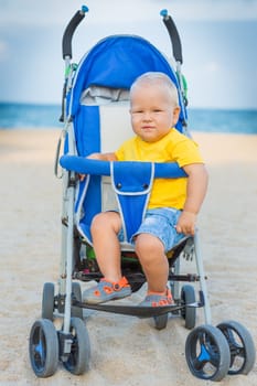 Adorable baby sitting in stroller