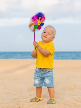 Baby playing with toy windmill