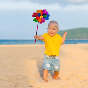Baby playing with toy windmill