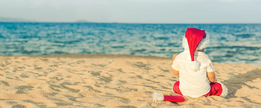 Little Santa on the beach. Panorama