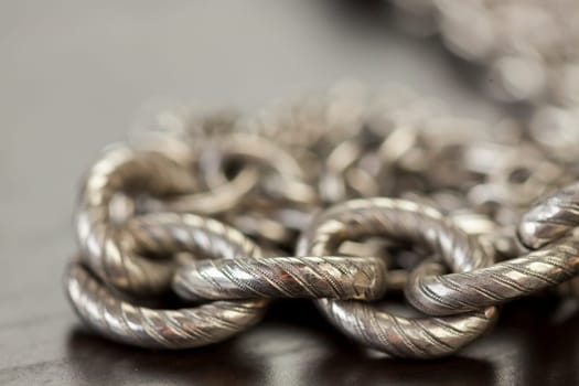 Silver jewels chains necklaces Armbanfmit Petrlen shiny on dark background