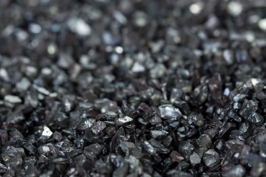 granular black asphalt in fine granules as close-up