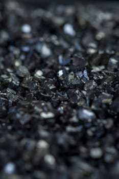 granular black asphalt in fine granules as close-up