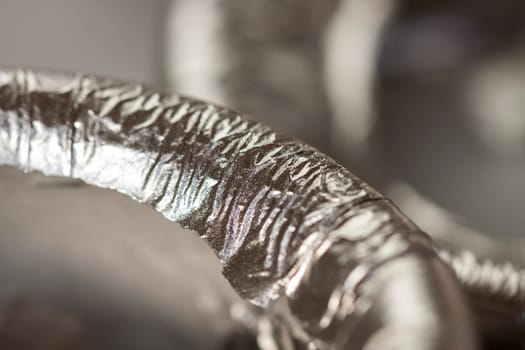 Extinguished wick of a silver candle as close-up detail