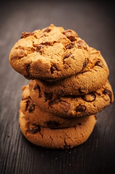 Pile of chocolate cookies on wooden table