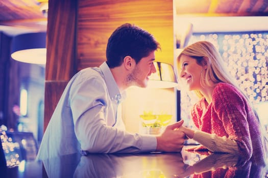 romantic evening date in restaurant  happy young couple with wine glass tea and cake