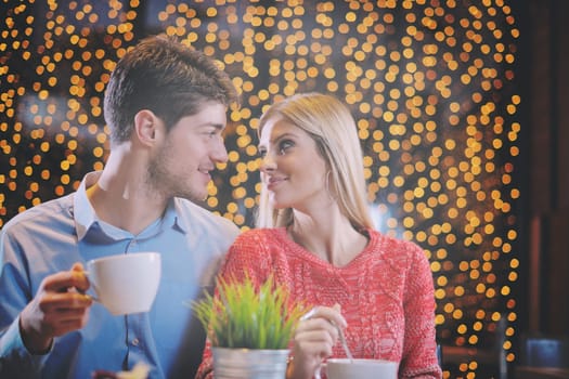 romantic evening date in restaurant  happy young couple with wine glass tea and cake