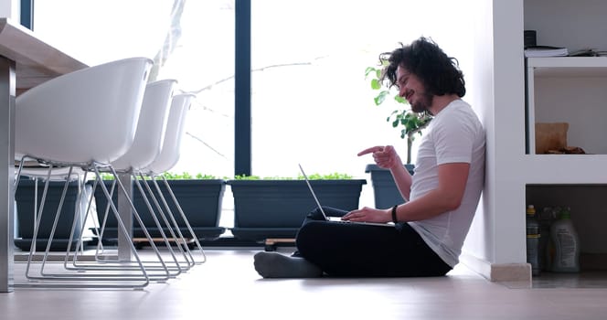 Real man Using laptop on the floor At Home  Enjoying Relaxing