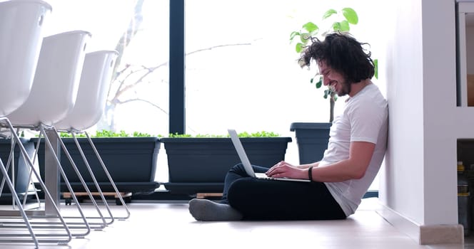 Real man Using laptop on the floor At Home  Enjoying Relaxing