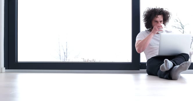 Real man Using laptop on the floor At Home  Enjoying Relaxing