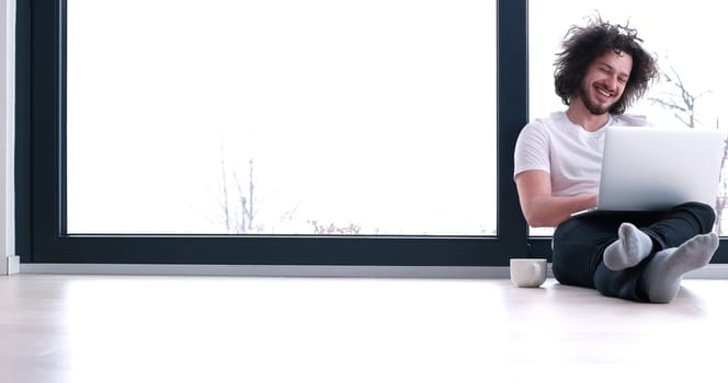 Real man Using laptop on the floor At Home  Enjoying Relaxing