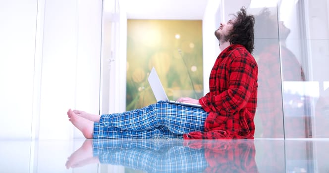 Real man Using laptop on the floor At Home  Enjoying Relaxing