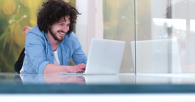 Real man Using laptop on the floor At Home  Enjoying Relaxing