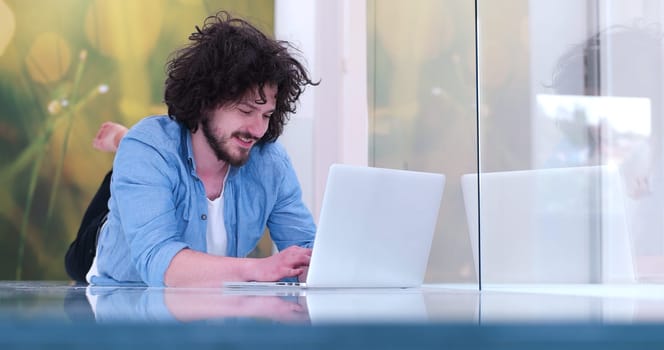 Real man Using laptop on the floor At Home  Enjoying Relaxing