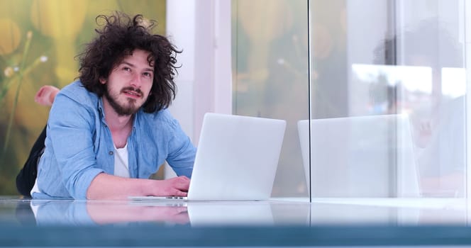 Real man Using laptop on the floor At Home  Enjoying Relaxing