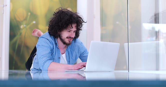 Real man Using laptop on the floor At Home  Enjoying Relaxing
