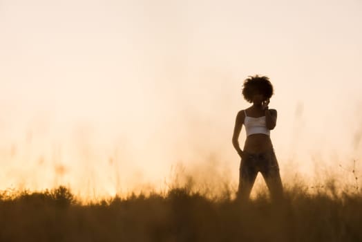 Healthy Looking Smiling Young African American Female beautiful summer evening in nature