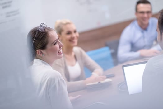 Group of a young business people discussing business plan at modern startup office building