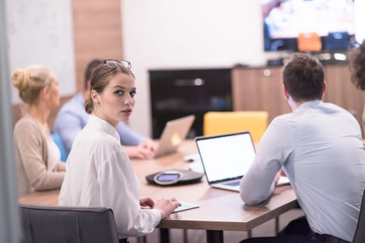 Group of a young business people discussing business plan at modern startup office building