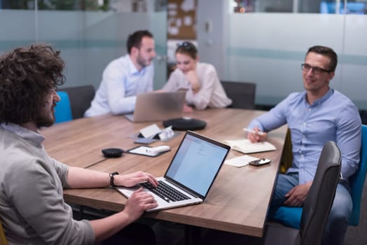 Group of a young business people discussing business plan at modern startup office building