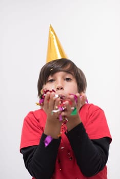 Happy kid celebrating party with blowing confetti