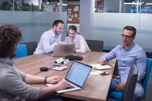Group of a young business people discussing business plan at modern startup office building