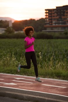young beautiful African American woman enjoys running outside beautiful summer evening in the city