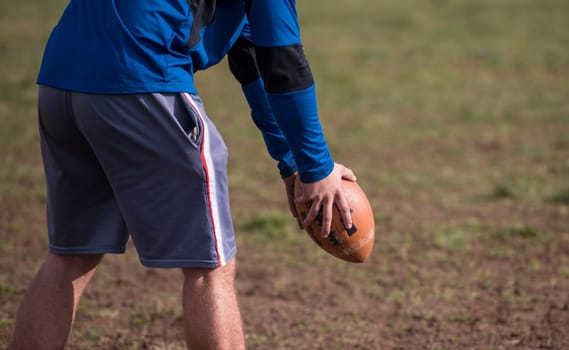 american football kicker practicing football kickoff closeup shot