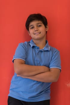 Portrait of a happy young boy in front of colored background