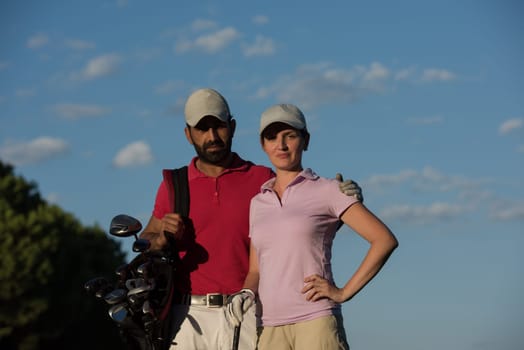 portrait of happy young  couple on golf course