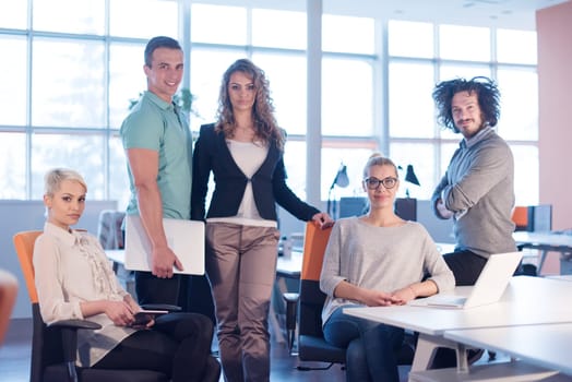 Portrait of young business people discussing business plan  in the office