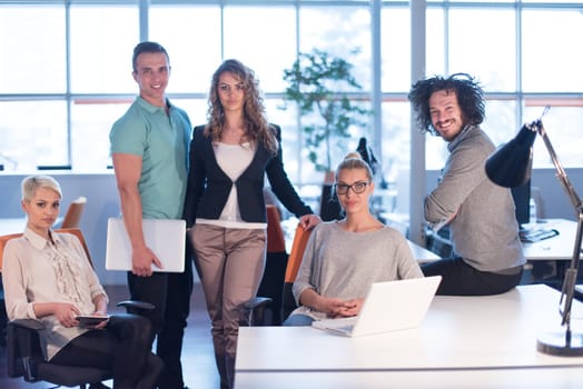 Portrait of young business people discussing business plan  in the office
