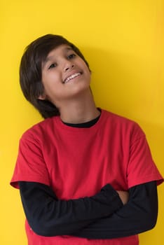 Portrait of a happy young boy in front of colored background