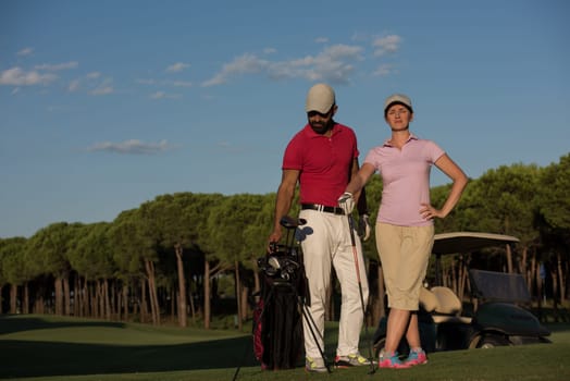 portrait of happy young  couple on golf course