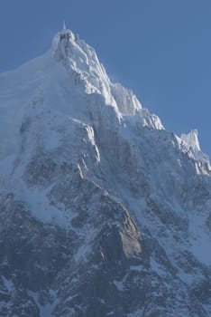 French alps mountain peaks covered with fresh snow. Winter landscape nature scene on beautiful sunny winter day.