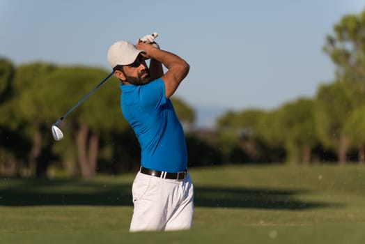pro golf player shot ball from sand bunker at course
