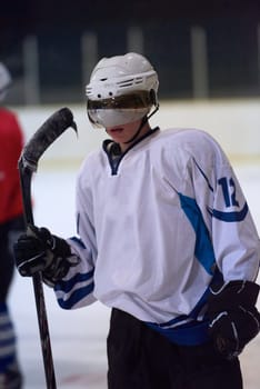 young ice hockey player portrait on training in black background