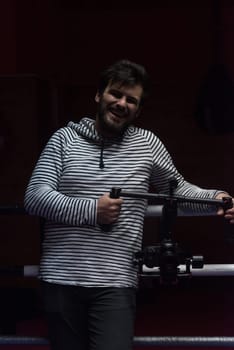 young videographer with gimball video slr at work
