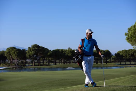 handsome middle eastern golf player portrait at course at sunny day