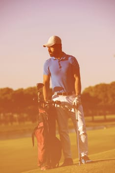 handsome middle eastern golf player portrait at course at sunny day