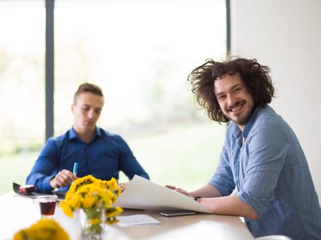 Group of a young business people discussing business plan at modern startup office building