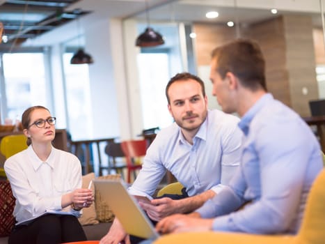 Group of a young business people discussing business plan at modern startup office building