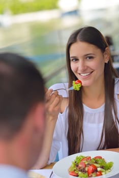 happy young couple having lanch at beautiful restaurant on by the sea on  beach