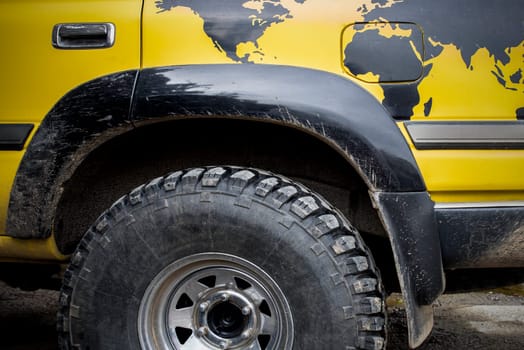 World traveller off road vehicle. A world map is painted over rear wheel