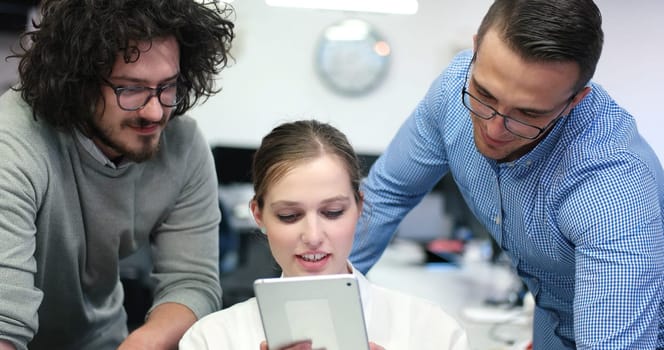 Group of a young business people discussing business plan at modern startup office building