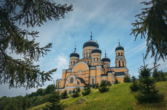 Beautiful outdoors view to Hancu Monastery, a traditional Christian Orthodox church located in the middle of the woods, Republic of Moldova. Eastern Europe basilica traditional architecture style