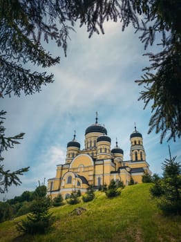Beautiful outdoors view to Hancu Monastery, a traditional Christian Orthodox church located in the middle of the woods, Republic of Moldova. Eastern Europe basilica traditional architecture style