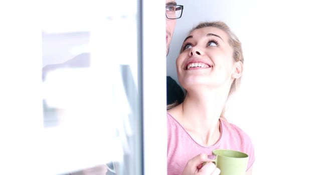 romantic happy young couple enjoying morning coffee by the window in their luxury home