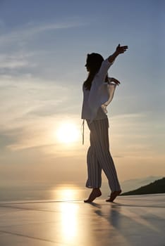 happy young woman enjoy sunset while dancing and enjoy music on headphones