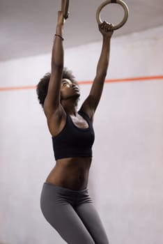 Fitness dip ring beautiful young african american woman workout at gym dipping exercise